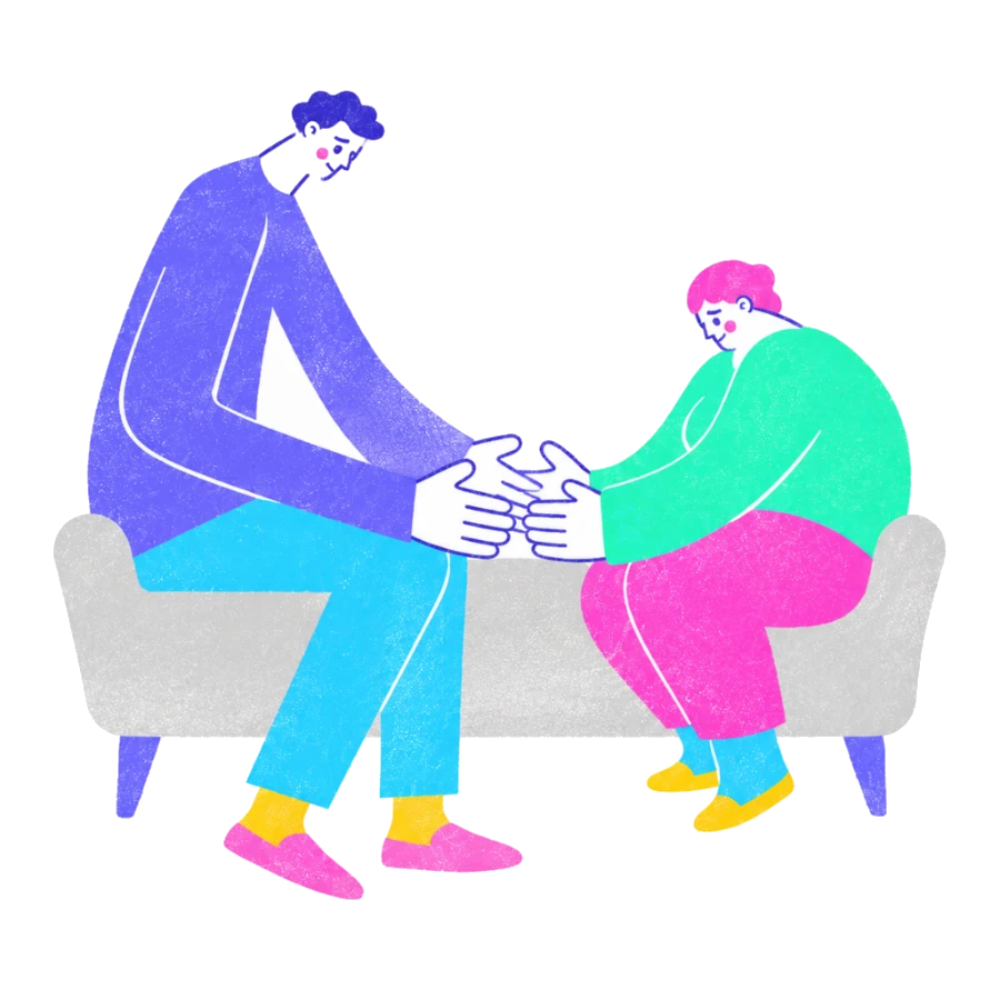 Fenweh: two partners on a sofa holding hands after a difficult conversation, illustrating couples therapy and repair